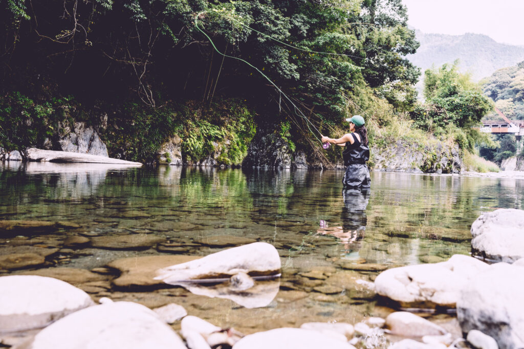 a woman fly fishing in Japan